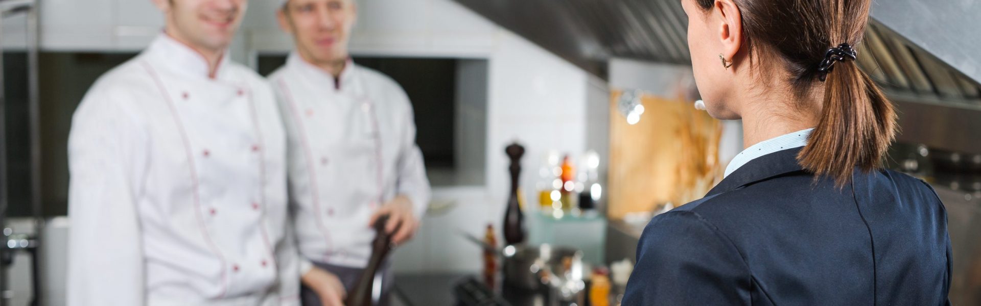 Restaurant manager briefing to his kitchen staff in the commercial kitchen